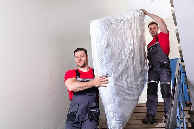 decluttering process involving the removal of a box spring in Fullerton